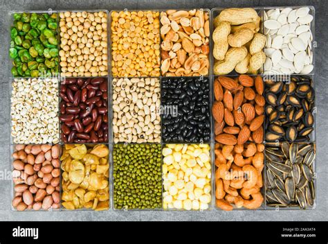 Box of different whole grains beans and legumes seeds lentils and nuts colorful snack texture ...