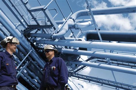 Oil and gas workers inside refinery industry Stock Photo by ©lagereek 104466846