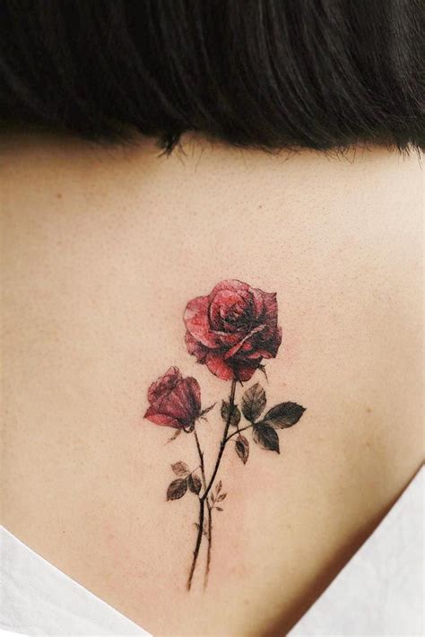 a woman with a tattoo on her neck has a single rose tattooed on the ...