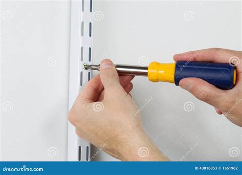 Installing Metal Bracket On Wall With Hand Screwdriver Stock Photo ...