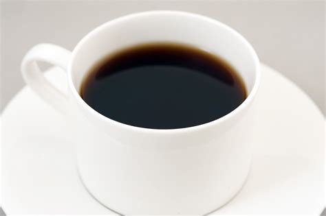 Black energizing coffee served in a white cup - Free Stock Image