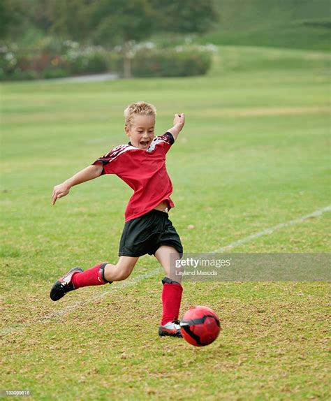 Boy Kicking Soccer Ball High-Res Stock Photo - Getty Images