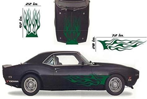 an old car with flames on the hood and side decals is shown in green