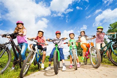 Kids in helmets with bikes Stock Photo by ©serrnovik 52715489