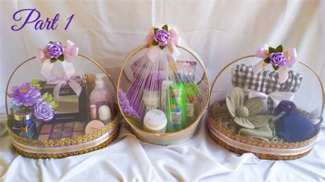 two baskets filled with personal care items on top of a white cloth ...