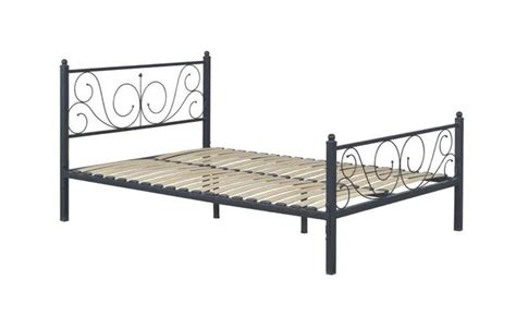 a metal bed frame with an intricate design