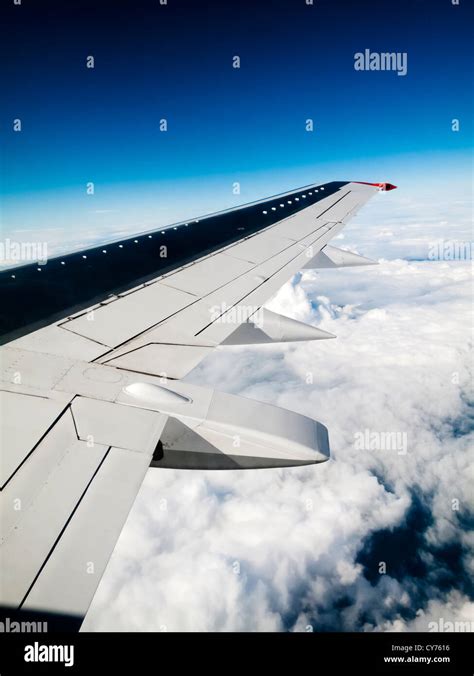 View of the wing of Boeing 737 passenger airliner flying above the ...