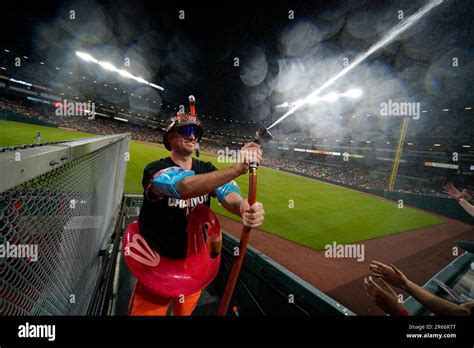 Mr. Splash sprays fans in the "Bird Bath Splash Zone" during the seventh inning of a baseball ...