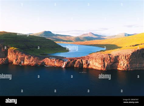 Aerial view from drone of Sorvagsvatn lake on cliffs of Vagar island in ...