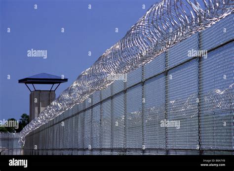 Prison: Fence, Guard Tower and Razor Wire Stock Photo - Alamy