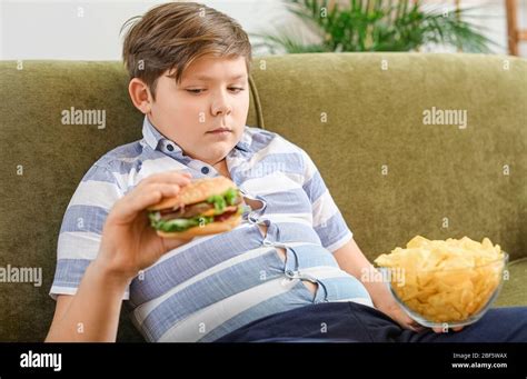 Overweight child eating junk food hi-res stock photography and images ...