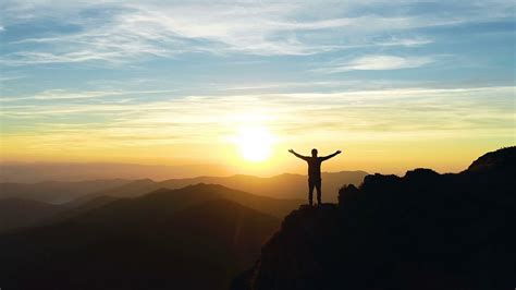 The happy male standing on the mountain and enjoying the sunrise Stock Video Footage - Storyblocks