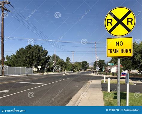 Yellow Railroad Crossing Sign in Front of Tracks Editorial Photo - Image of outside, yellow ...