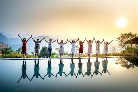 Satisfied people gathering on poolside on sunset · Free Stock Photo