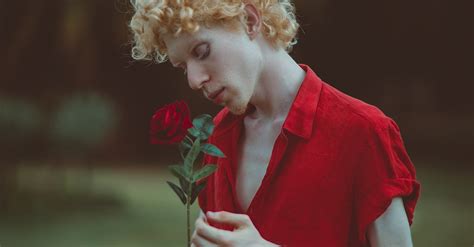 Man In Red Top Holding A Red Rose · Free Stock Photo