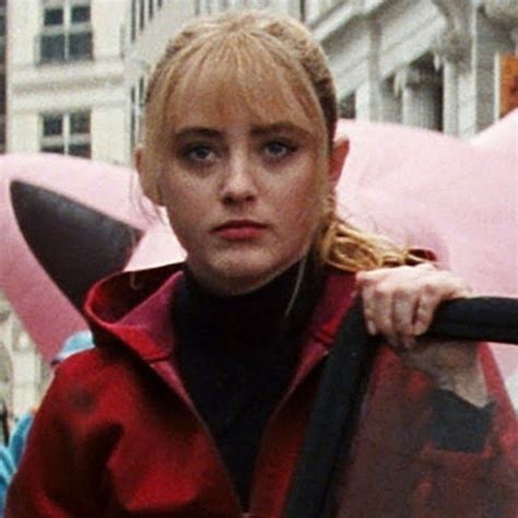 a woman with blonde hair holding an umbrella