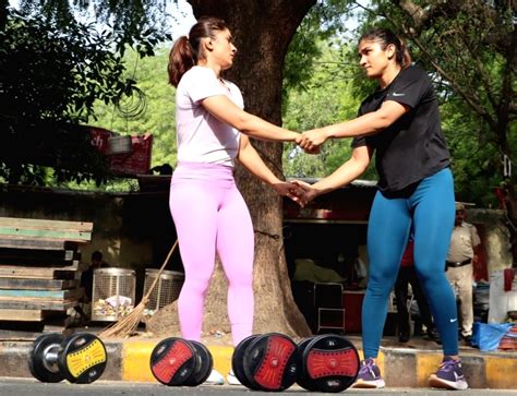 New Delhi : Wrestler Vinesh Phogat with fellow wrestlers during a ...