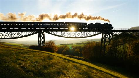 Epic Aerial View Of Steam Engine Train Crossing Bridge At Sunset Magic Hour. Old Locomotive ...