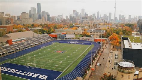 Premium Photo | Aerial view of football stadium against city skyline