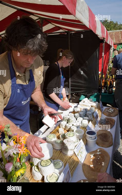 Market stallholders putting cheese on display at Abergavenny Food ...