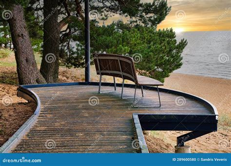 A View of a Wooden Platform with One Wooden Bench Overlooking Lake ...