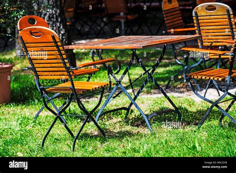 German Beer Garden With Wooden Furniture Stock Photo - Alamy