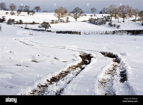 Tractor tracks in the snow Stock Photo - Alamy