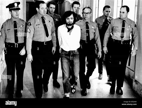 Charles Manson, 1971, being led away in handcuffs after being found ...