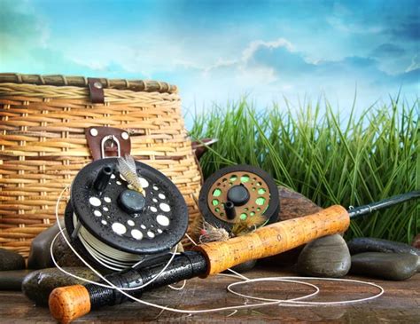 Fly fishing equipment with hat on wooden dock — Stock Photo ...