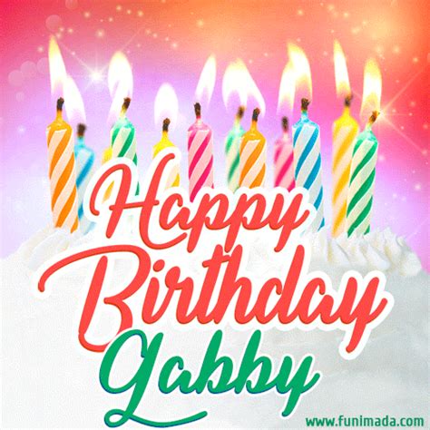 A white creme cake with colorful candles and the words 'Happy Birthday Gabby' in a handwritten ...