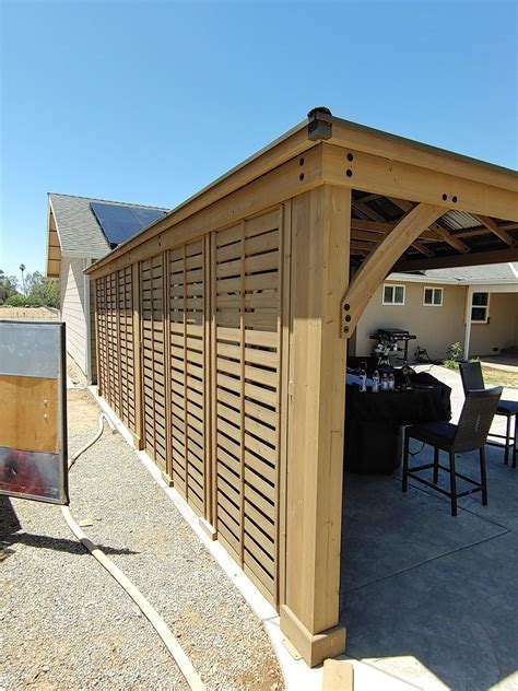 an outdoor patio area with wooden slats on the roof