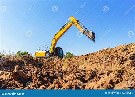 Backhoe Digging Up Soil To Prepare Agricultural Land Stock Photo - Image of digger, development ...