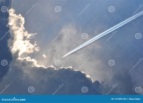 Jet Vapor Trail Against a Cloudy Sky Stock Photo - Image of atmosphere ...