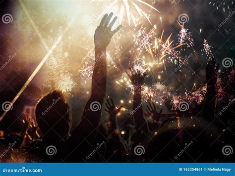 New Year Concept - Cheering Crowd and Fireworks Stock Image - Image of ...