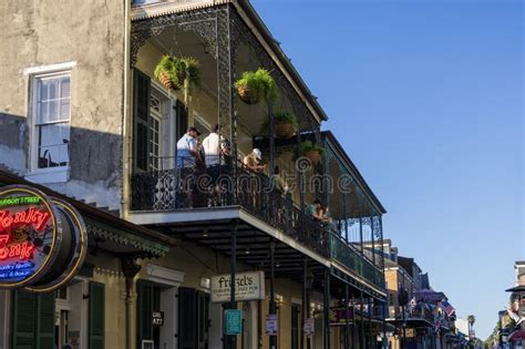 People Standing on a Balcony Having Drinks on Bourbon Street with ...