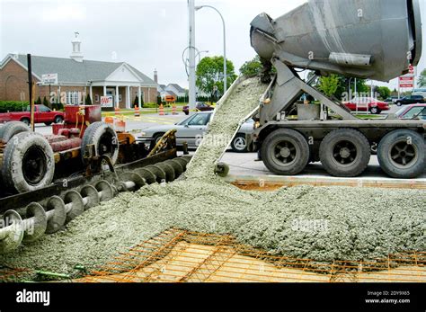 Cement truck pouring cement for a new concrete road Stock Photo - Alamy