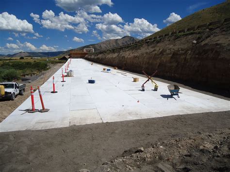 construction is underway on the side of a road near a mountain range ...