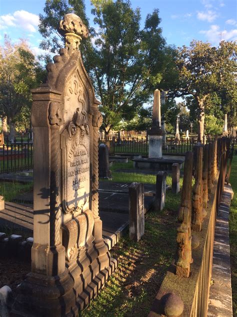 an old cemetery with many headstones and trees in the background