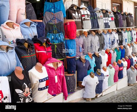 Counterfeit or fake designer clothing for sale outside shop in the busy harbour area of Kalkan ...