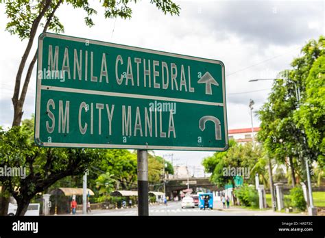 Manila Cathedral sign. Road sign in Manila directing traffic to Manila ...