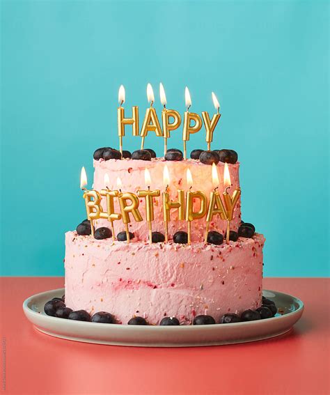 "Happy Birthday Cake With Lit Candles." by Stocksy Contributor "Martí Sans" - Stocksy