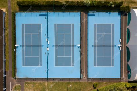 Premium Photo | Aerial view of three tennis courts