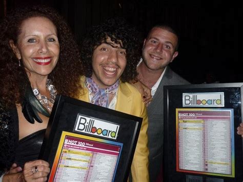 two women and one man are holding up an award for their work on billboards