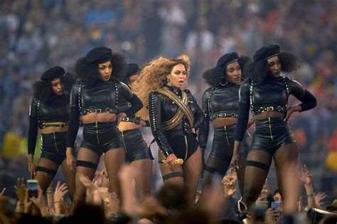 a group of women standing on top of a stage