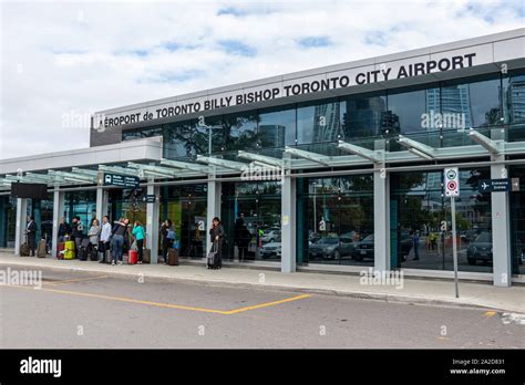 Passengers waiting out front of Billy Bishop Toronto City Airport at ...