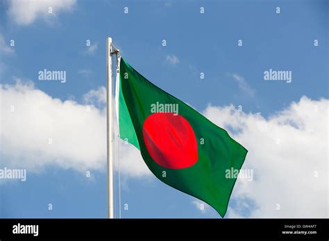 National flag of Bangladesh on a flagpole in front of blue sky Stock Photo - Alamy