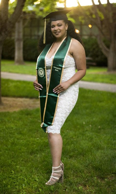 a woman wearing a green and gold graduation sash