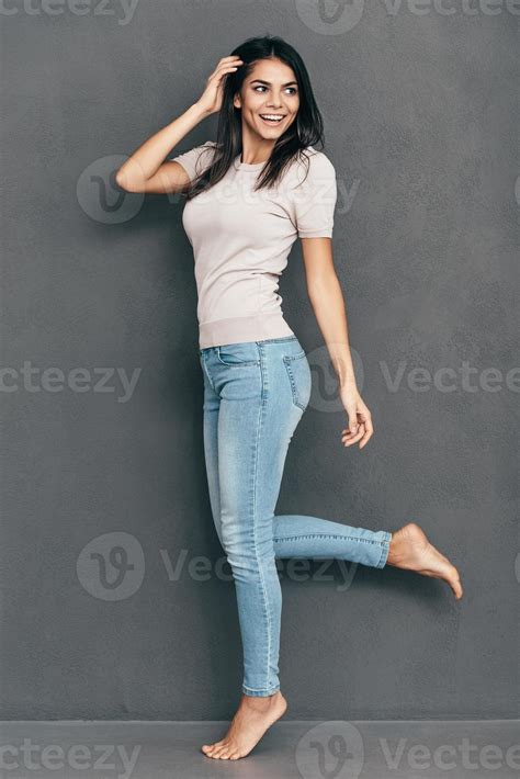 Casual and so beautiful. Full length of attractive young woman in casual wear holding hand in ...