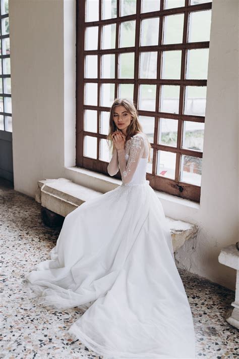 Off-white wedding dress with sheer long sleeve embroidered bodice | Cathy Telle