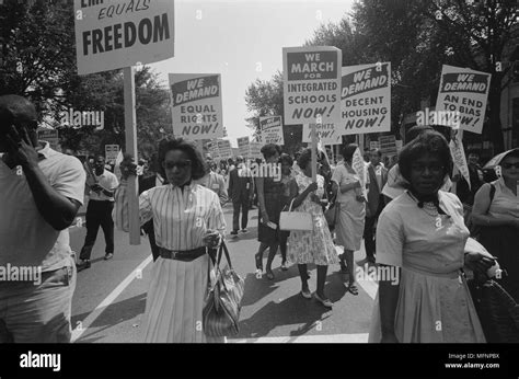 Civil rights march on Washington, DC, USA. Procession of African Americans carrying placards ...